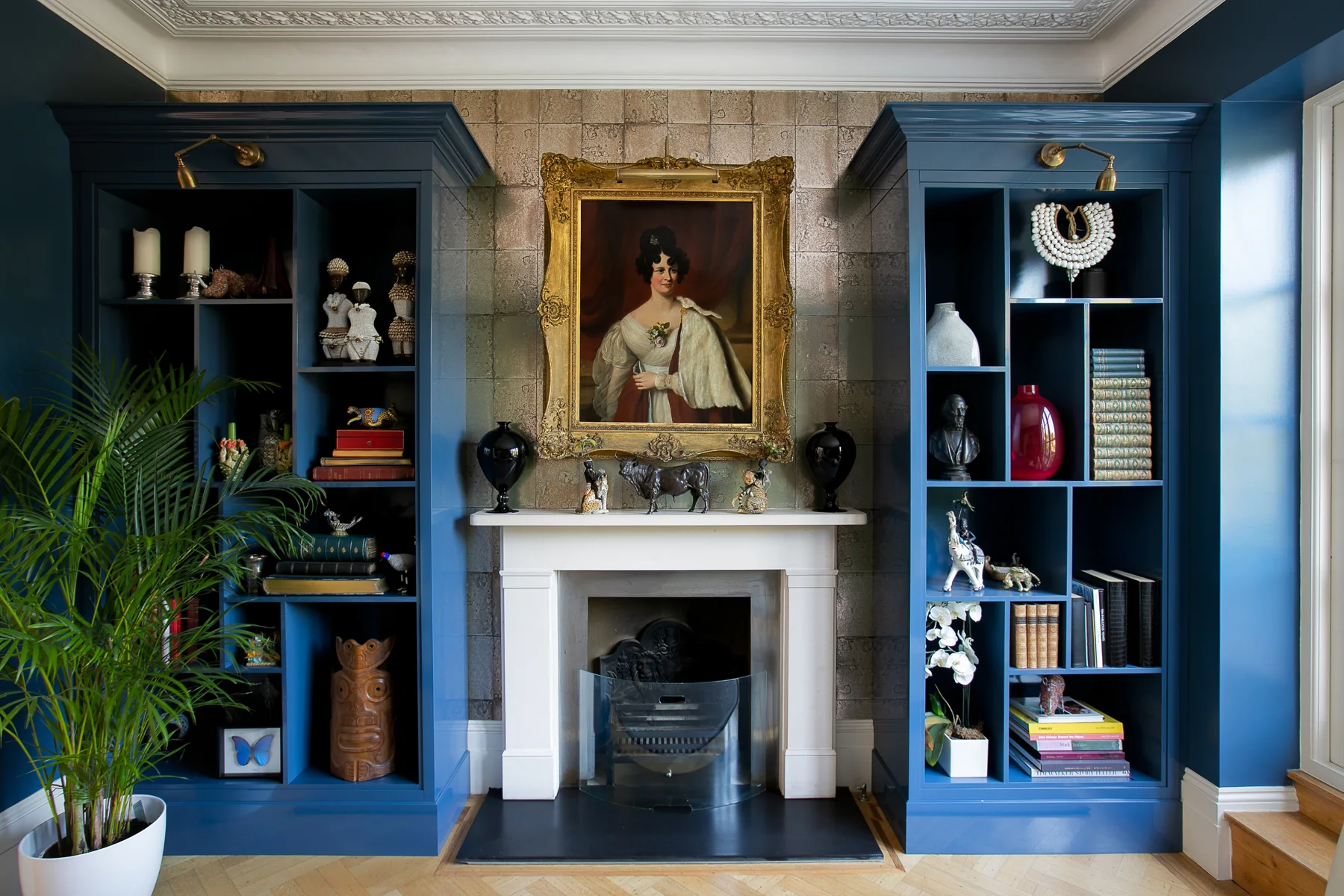 Blue lacquer cabinetry and brass details in a Wandsworth cocktail room