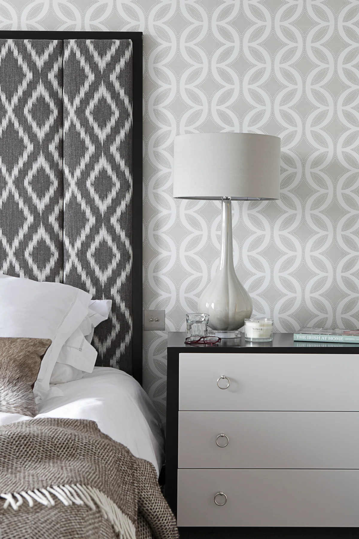 Patterned wallpaper and a framed upholstered headboard in Dublin